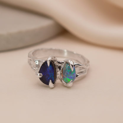 silver ring with two opals, in a claw setting