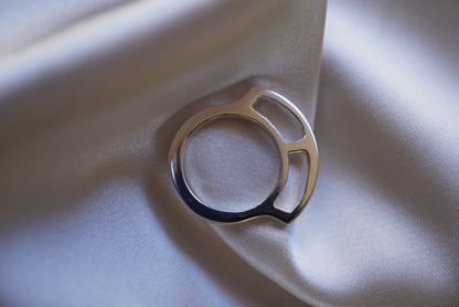 Silver ring on a light fabric background